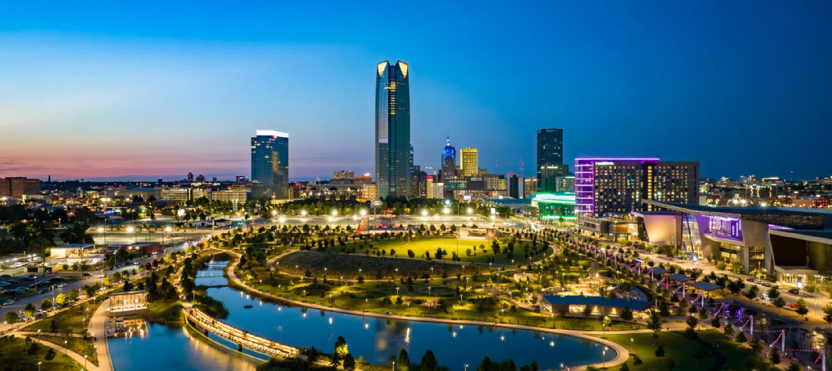 Aerial twilight view of the Oklahoma City skyline featuring Scissortail Park and Devon Energy Center for LumaDent regional event page