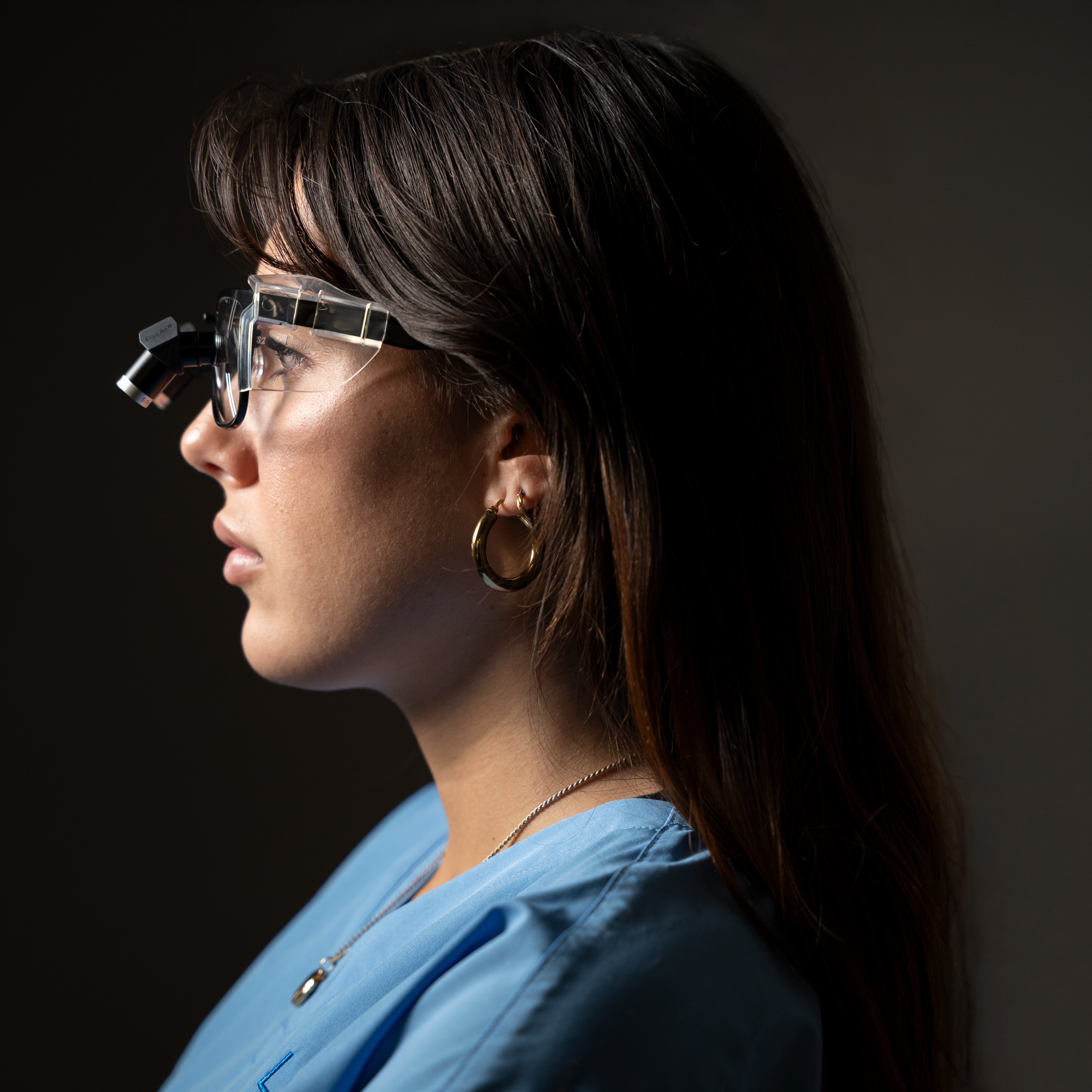 Woman wearing futuristic eyeglasses against a dark background